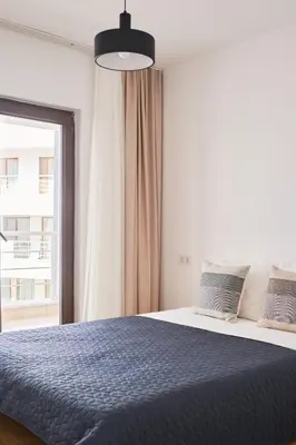 a bedroom with a blue bed with a window at Stunning Sea View, Peaceful Family Villa with AC, Sauna, Gym & Shared Pool in Silivri