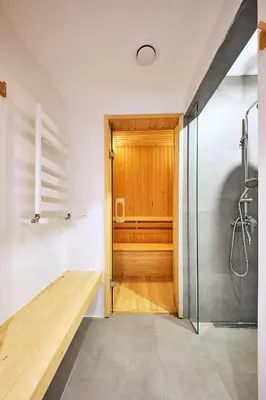 a bathroom with a shower and a wooden door at Stunning Sea View, Peaceful Family Villa with AC, Sauna, Gym & Shared Pool in Silivri