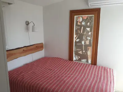 a bedroom with a bed with a red striped blanket at Art & Natura in Marmara