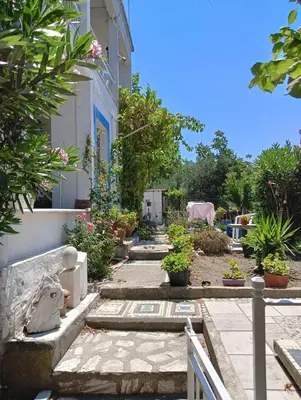a house with a garden with potted plants at Art & Natura in Marmara