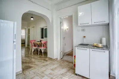 a kitchen with white cabinets and a dining room at HANLAR Apart in Istanbul