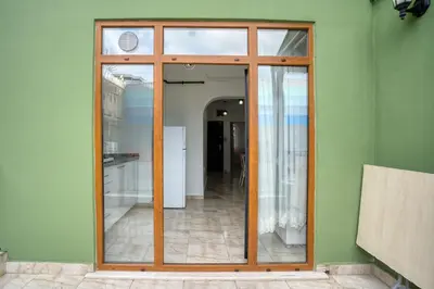 a large glass door in a green wall at HANLAR Apart in Istanbul
