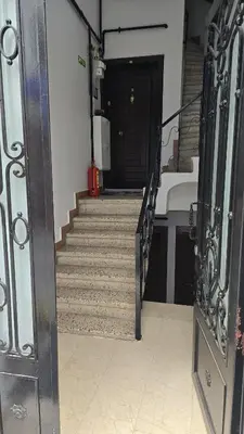 a hallway with stairs with a black door and a black door at HANLAR Apart in Istanbul