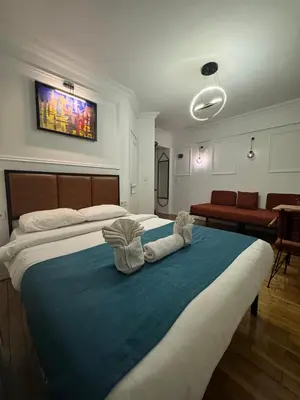 a bedroom with a large bed with towels on it at Veva flats hotel in Istanbul