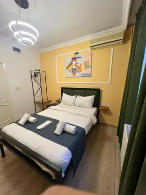 a bedroom with a large bed with two pillows on it at 24Suitetaksim in Istanbul