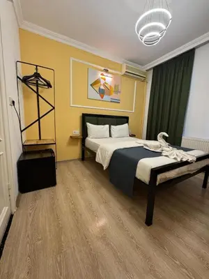 a bedroom with a bed in a room with at 24Suitetaksim in Istanbul