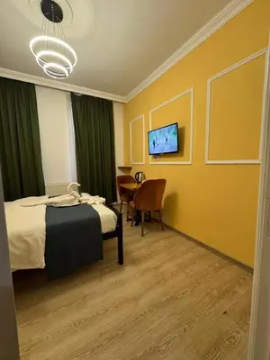 a hotel room with a bed and a table and chairs at 24Suitetaksim in Istanbul