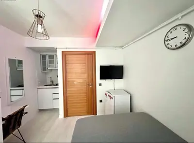 a room with a door and a clock on the wall at Innova Suit Hotel in Istanbul
