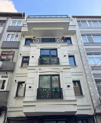 a tall white building with a balcony at Innova Suit Hotel in Istanbul