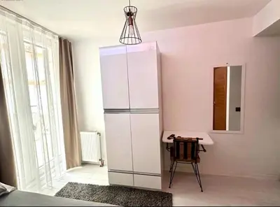 a white cabinet in a room with a table at Innova Suit Hotel in Istanbul