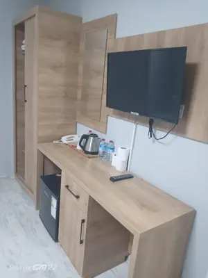 a wooden desk with a television on top of it at Tekirdağ Begonya Hotel in Kapaklı