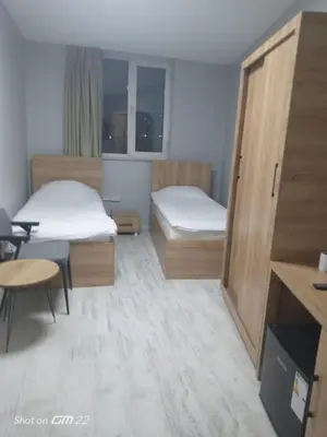 a small room with two beds and a table at Tekirdağ Begonya Hotel in Kapaklı