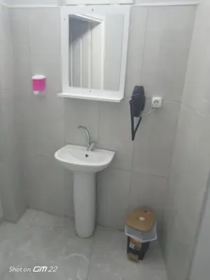 a white bathroom with a sink and a mirror at Tekirdağ Begonya Hotel in Kapaklı