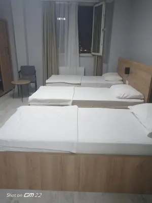 a group of four beds in a room at Tekirdağ Begonya Hotel in Kapaklı