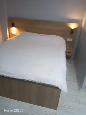 a bedroom with a bed with white sheets on it at Tekirdağ Begonya Hotel in Kapaklı