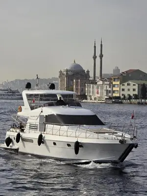 a white boat in the water with buildings in the background at Rotavira YAT KİRALAMA PLATFORMU in Istanbul