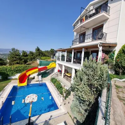 a house with a pool and a water slide at Luxury Family Villa with Private Pool & Slide in Gemlik