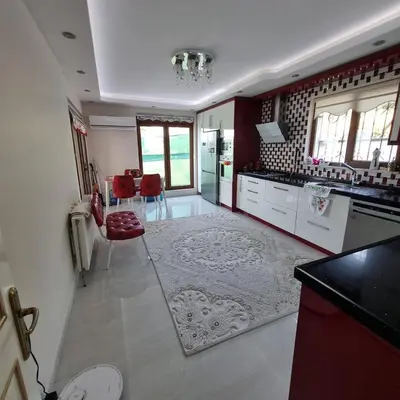 a large kitchen with red and white appliances at Luxury Family Villa with Private Pool & Slide in Gemlik