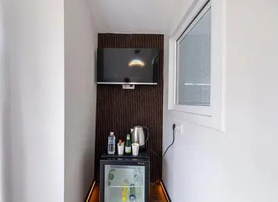 a small refrigerator in a room with a window at Galata heart suits in Istanbul