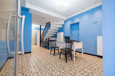 an office with blue walls and a table and chairs at Galata heart suits in Istanbul