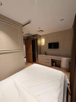 a bedroom with a white bed and a flat screen tv at City Istiklal in Istanbul