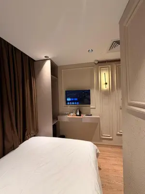 a bedroom with a bed and a tv on the wall at City Istiklal in Istanbul