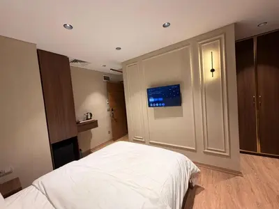 a bedroom with a bed and a tv on the wall at City Istiklal in Istanbul