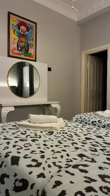 a bedroom with a bed with a black and white rug at Taksim Green Flat Apartment 2 in Istanbul