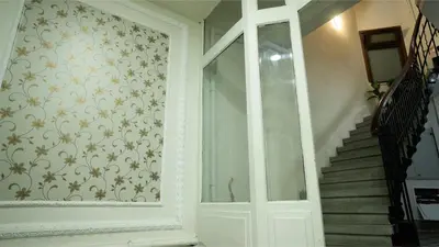 a room with a door and a staircase with a patterned wall at Taksim Green Flat Apartment 2 in Istanbul