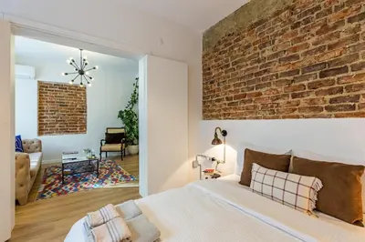a bedroom with a brick wall and a bed at 2BR Historical apartment 5 min to Taksim Sq in Istanbul