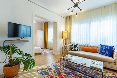 a living room with a couch and a tv at 2BR Historical apartment 5 min to Taksim Sq in Istanbul