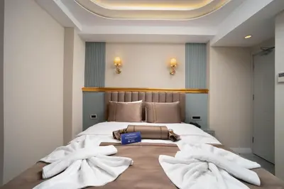 a bedroom with a large bed with towels on it at Hotel De Bonte in Istanbul