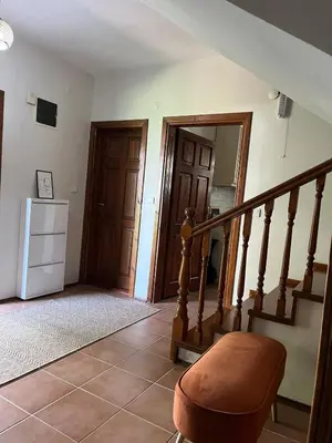 a room with a staircase with a chair and a refrigerator at Selbeshome in Sapanca