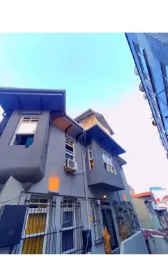 a tall blue building with windows and a balcony at Taksim Cinar Suit in Istanbul