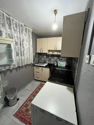 a small kitchen with white cabinets and a stove at Taksim metro central Suites hotel in Istanbul