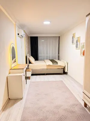 a bedroom with a bed and a table and a rug at Luxury Apartment In A Great Location 10 in Istanbul