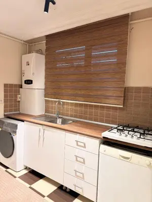 a white kitchen with a sink and a refrigerator at Luxury Apartment In A Great Location 10 in Istanbul