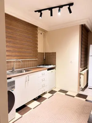 a kitchen with white cabinets and a sink at Luxury Apartment In A Great Location 10 in Istanbul