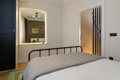 a bedroom with a bed and a mirror at Premium Family House for 10 Near Taksim in Istanbul