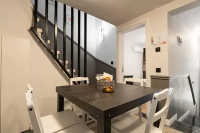 a dining room with a black table and white chairs at Premium Family House for 10 Near Taksim in Istanbul