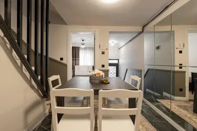 a dining room with a table and white chairs at Premium Family House for 10 Near Taksim in Istanbul