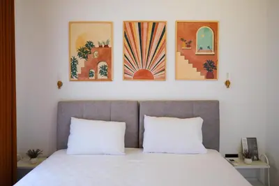 a bedroom with a bed with three paintings on the wall at Villa Wonka Sapanca Sıcak Havuz in Sapanca