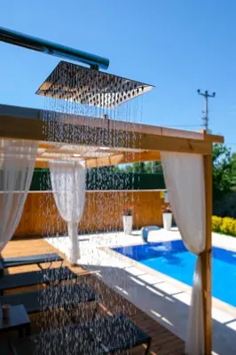 a water fountain in front of a swimming pool at Villa Wonka Sapanca Sıcak Havuz in Sapanca
