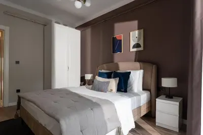 a bedroom with a large bed with blue pillows at Renovated Flat near Tram All Rooms AC in Istanbul