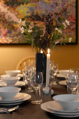 a table with a candle and plates and glasses at Renovated Flat near Tram All Rooms AC in Istanbul