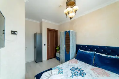 a bedroom with a blue bed with a blue headboard at Boutique Sultan Hotel & Restauran in Istanbul