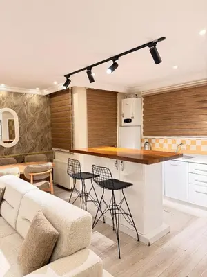 a kitchen and living room with a couch and a counter at Great Location Terrace Apartment 15 in Istanbul