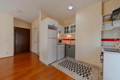 a kitchen with white appliances and a wooden floor at Spacious 1-Bedroom Apartment with Bosphorus View in Istanbul