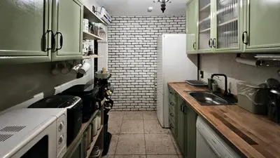 a small kitchen with green cabinets and a sink at Villa Nest Uludağ in Hüseyinalan