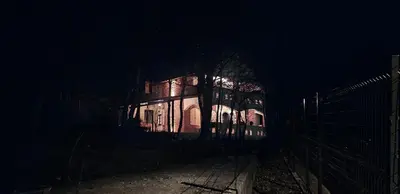a building lit up at night in the dark at Villa Nest Uludağ in Hüseyinalan